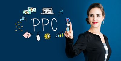 a woman is pointing at a ppc sign