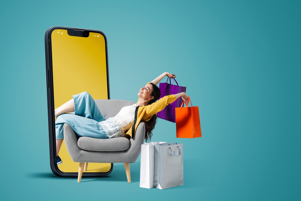 a woman laying on a couch next to a phone