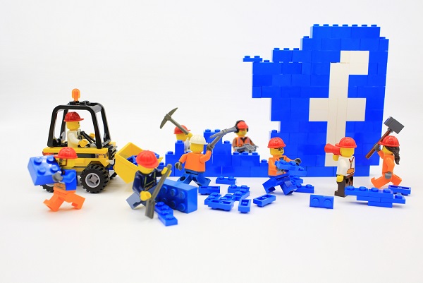 a group of legos building Facebook logo